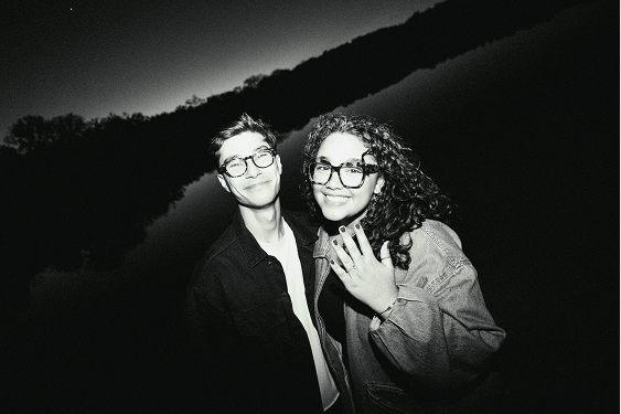 Daniel and Luzmarie showing their engagement ring by the lake